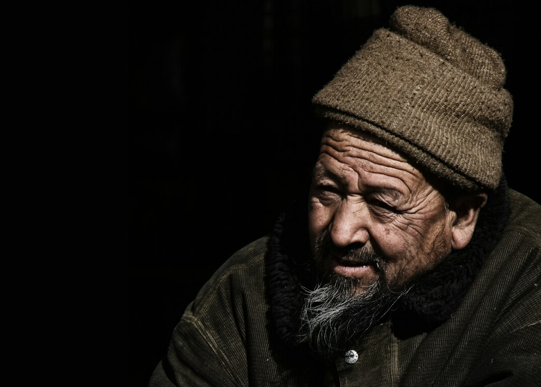 Studio photo of an older man with a beard