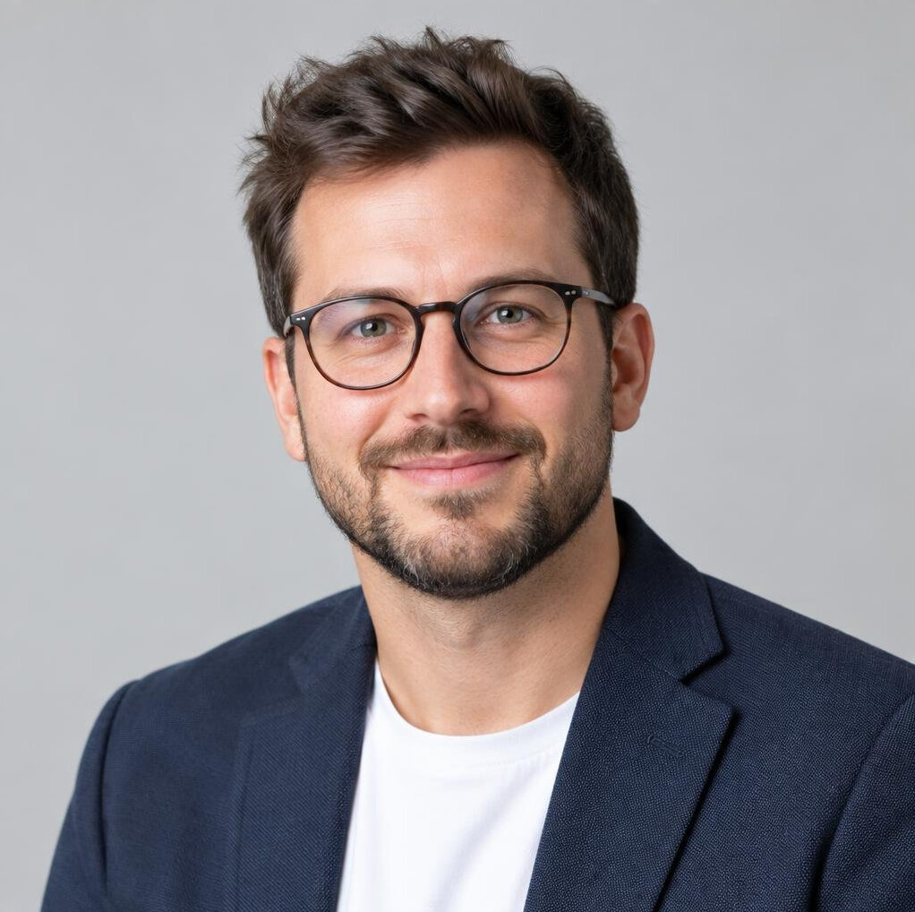 Studio photo of a young man with glasses